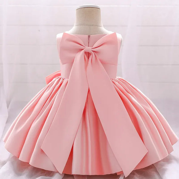 baby pink party dress for toddlers with large bow and sleeveless design