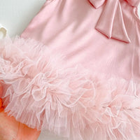 baby pink party dress for toddlers with bow detail and ruffled tulle hem