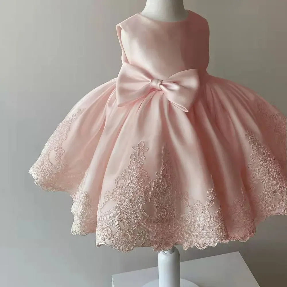 baby girls pink party dress with bow and lace detailing, sleeveless design