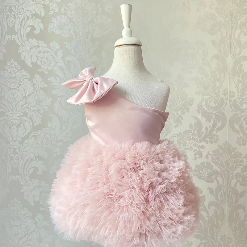 baby pink party dress with one-shoulder bow and fluffy tulle skirt for infants