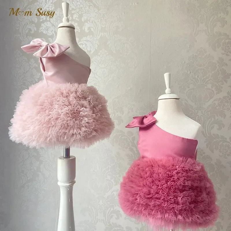 Girls pink party dress with one shoulder bow and fluffy tulle skirt for babies and kids