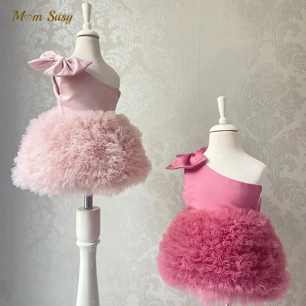 Girls pink party dress with one shoulder bow and fluffy tulle skirt for babies and kids