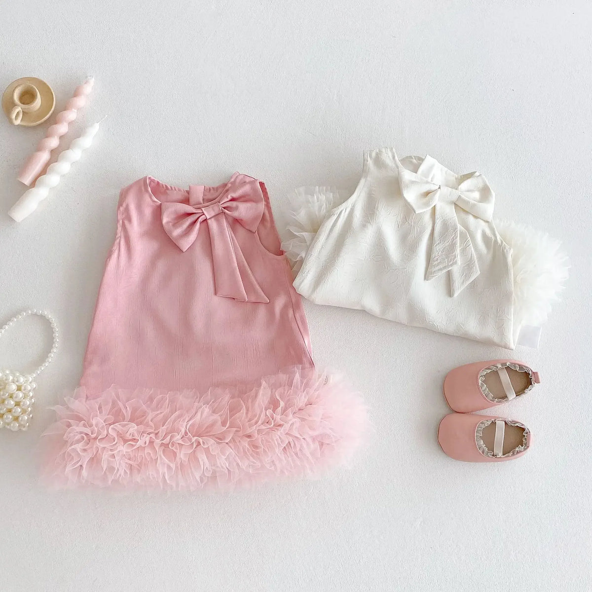 Pink and white baby party dress with bow detail and ruffled hem for infant girls