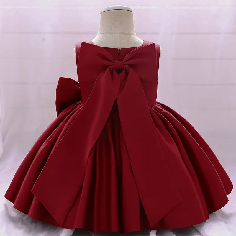 Girls red party dress with large bow detail and sleeveless design for toddlers