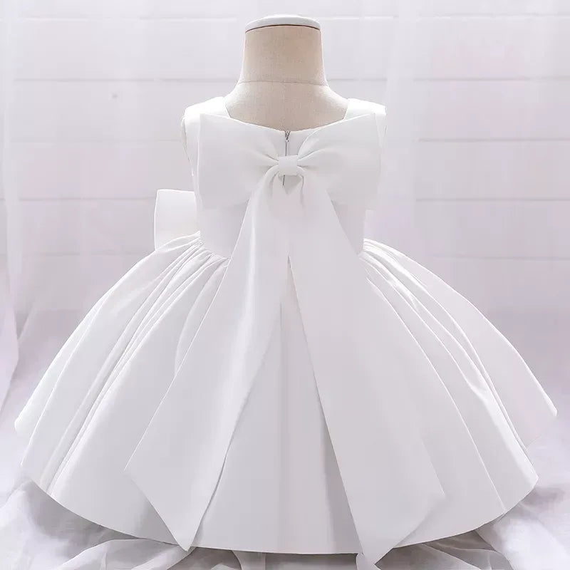 White baby party dress for girls with large bow and sleeveless design