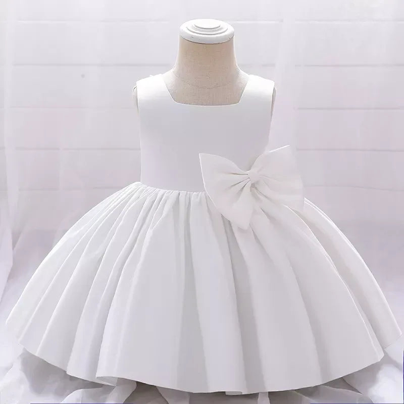 white baby girl party dress with sleeveless bodice and large side bow detail