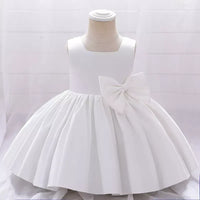 white baby girl party dress with sleeveless bodice and large side bow detail