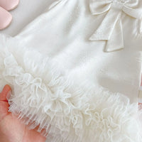 white baby party dress with bow detail and ruffled tulle hem for infants