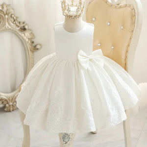 Girls white party dress with bow and lace details, sleeveless toddler size