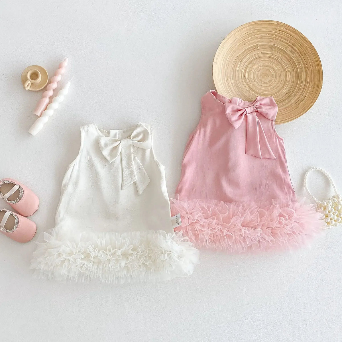 Toddler girls party dress in white and pink with bow detail and fluffy tulle hem for babies and kids