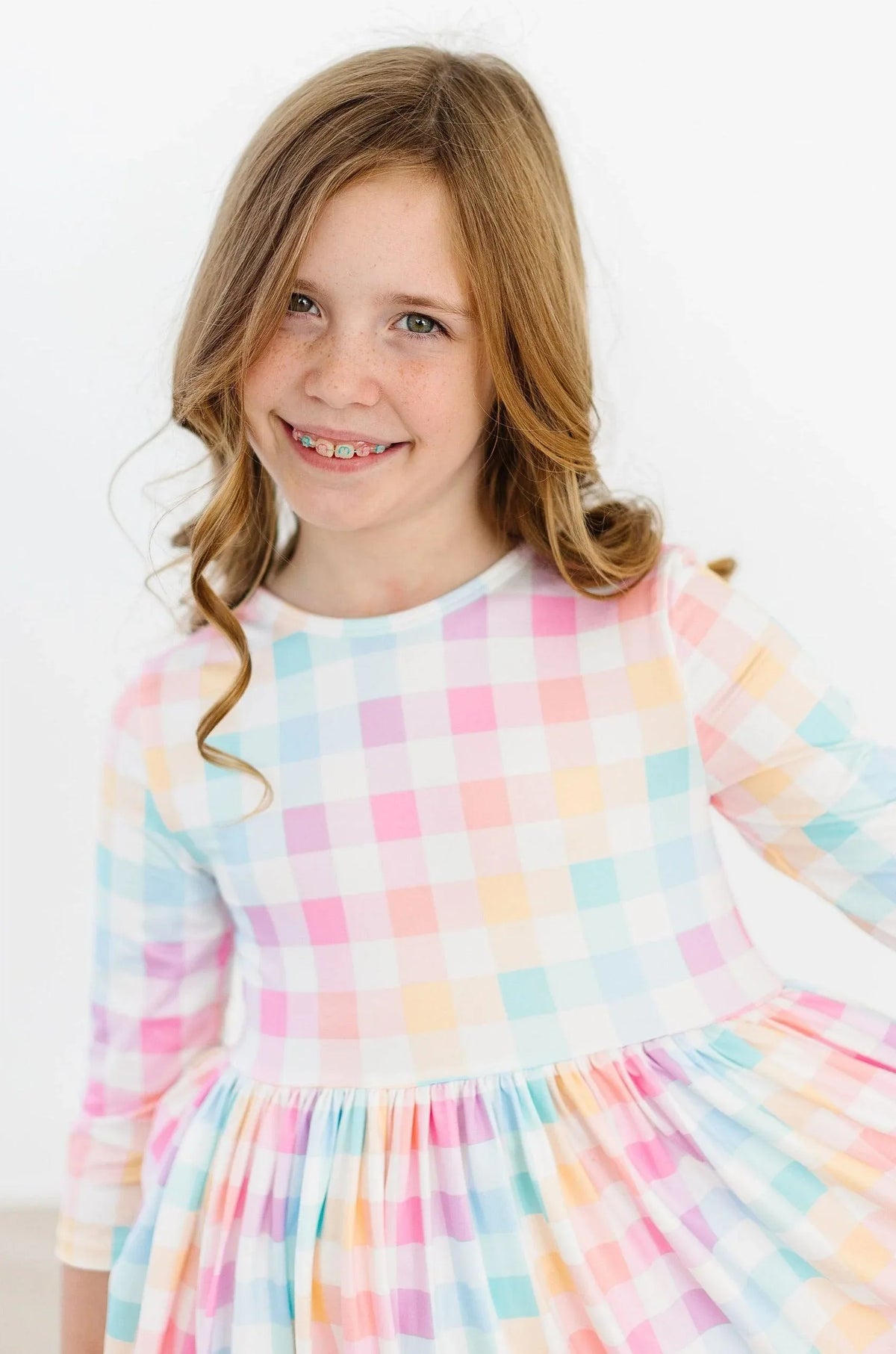 Girls pastel plaid girls twirl dress by Mila Rose with 3 4 sleeves and pocket detail