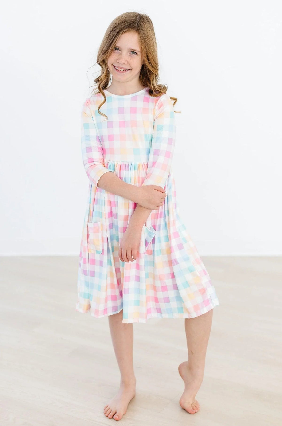 Pastel plaid girls twirl dress with 3/4 sleeves and pockets in soft multicolor for kids