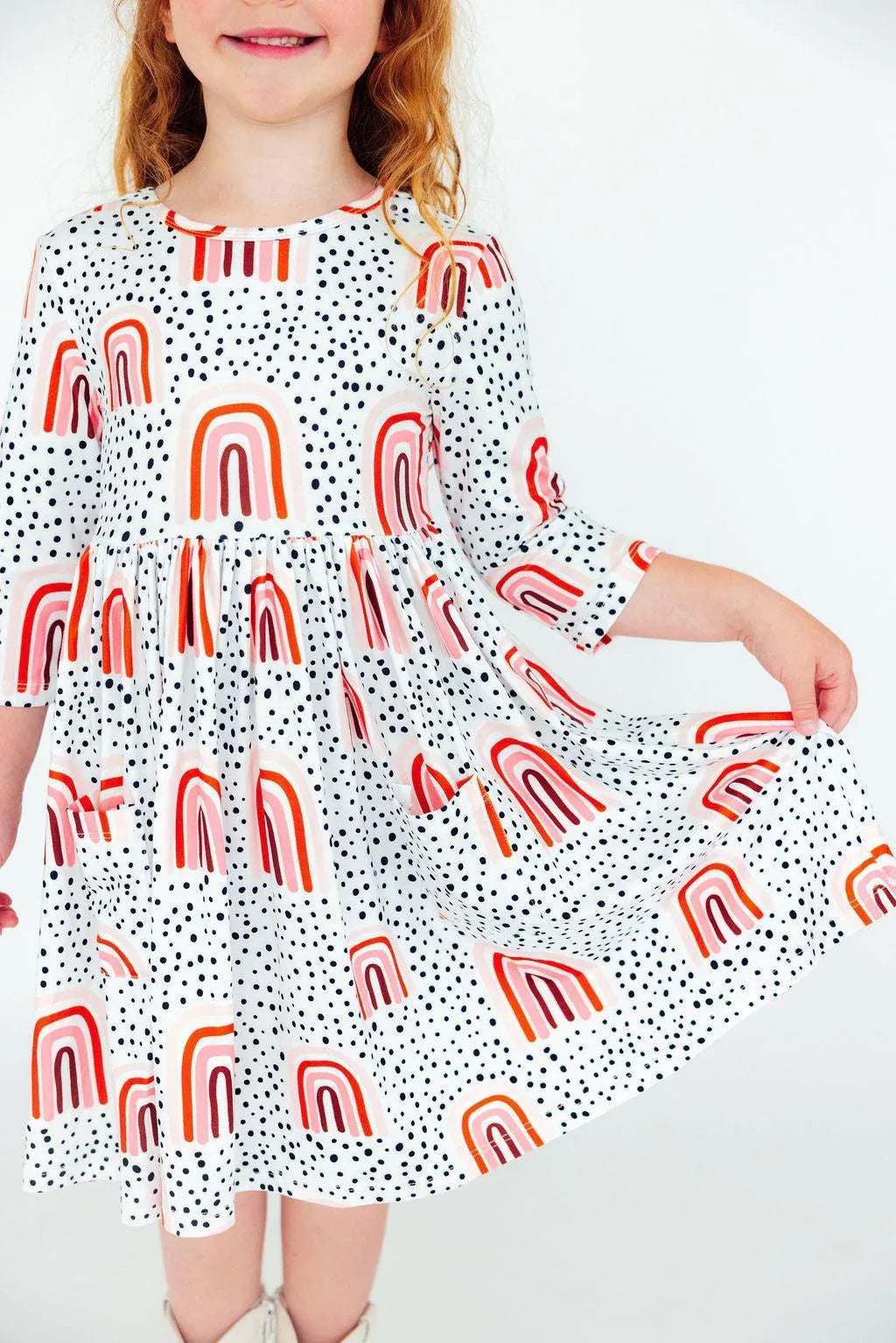 Girls peach rainbow twirl dress with 3/4 sleeves and pocket from Mila & Rose
