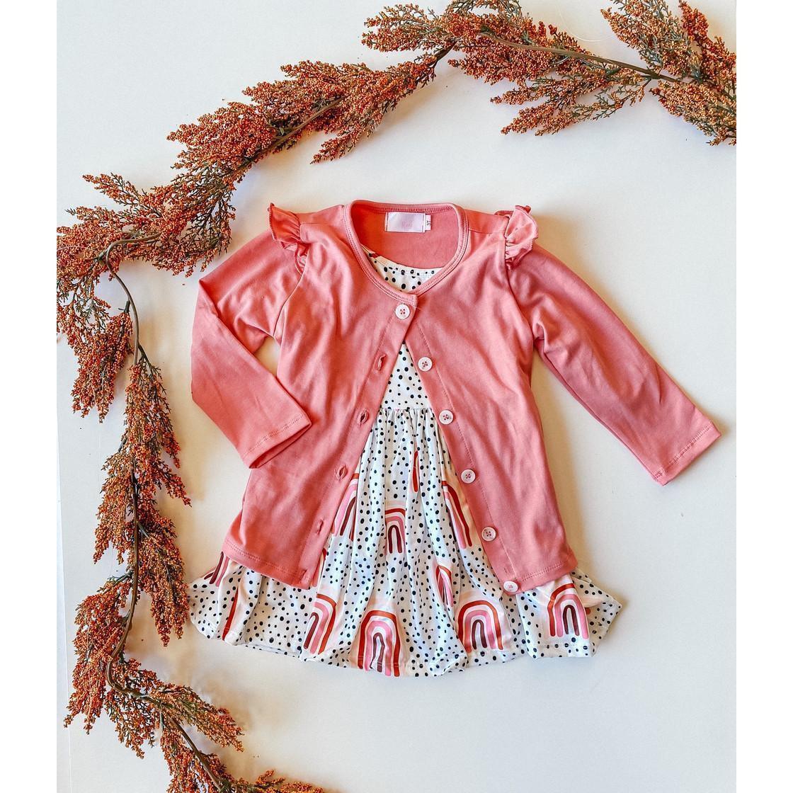 Toddler peach rainbow twirl dress with white polka dot and rainbow print, paired with pink 3/4 sleeve cardigan