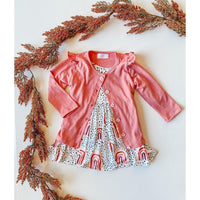 Toddler peach rainbow twirl dress with white polka dot and rainbow print, paired with pink 3/4 sleeve cardigan