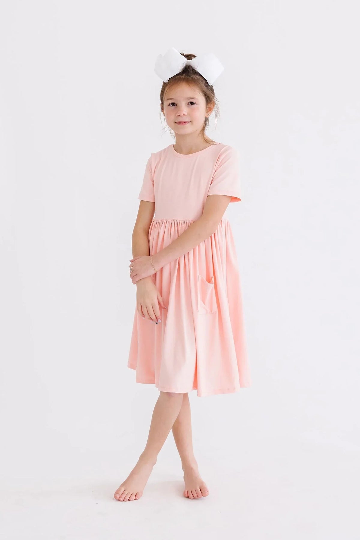 Peach twirl dress for girls with short sleeves and pockets, knee-length size for children