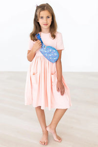 Peach twirl dress for girls by Mila & Rose with short sleeves and pockets, knee-length