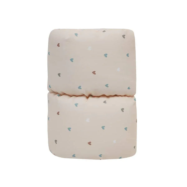 Beige cotton nursing pillow for babies with small multicolor heart prints by Goosewaddle