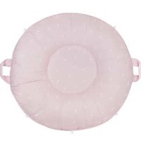 Pink floor cushion for toddlers made of soft fabric with small white star patterns and side handles
