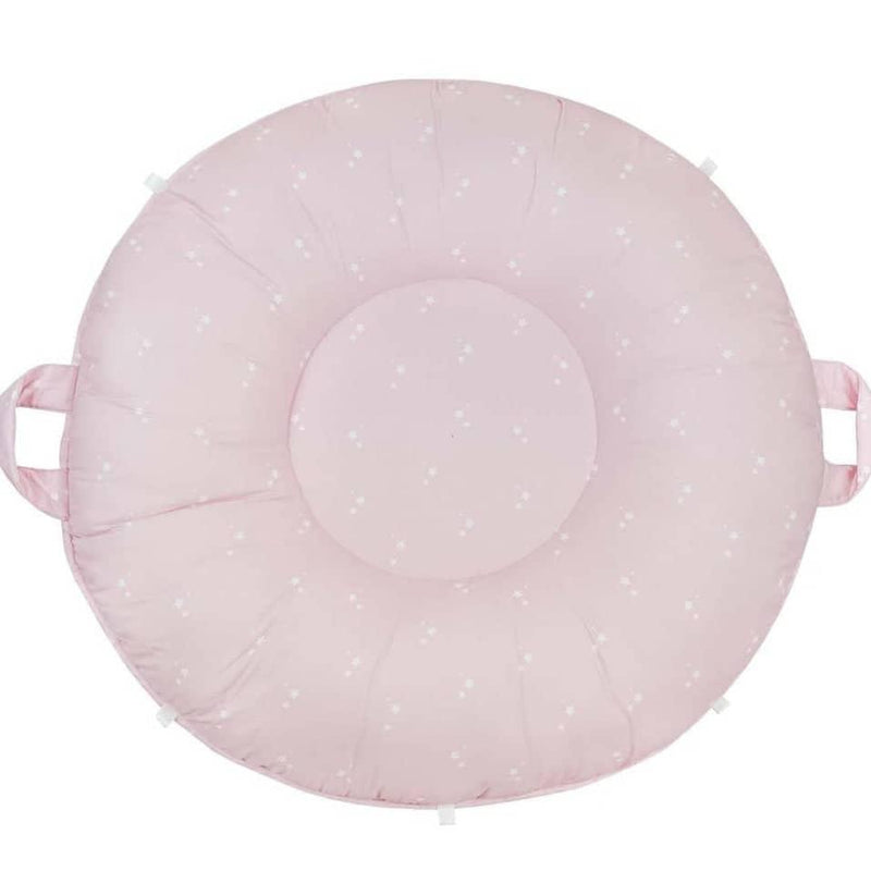 Pink floor cushion for toddlers made of soft fabric with small white star patterns and side handles