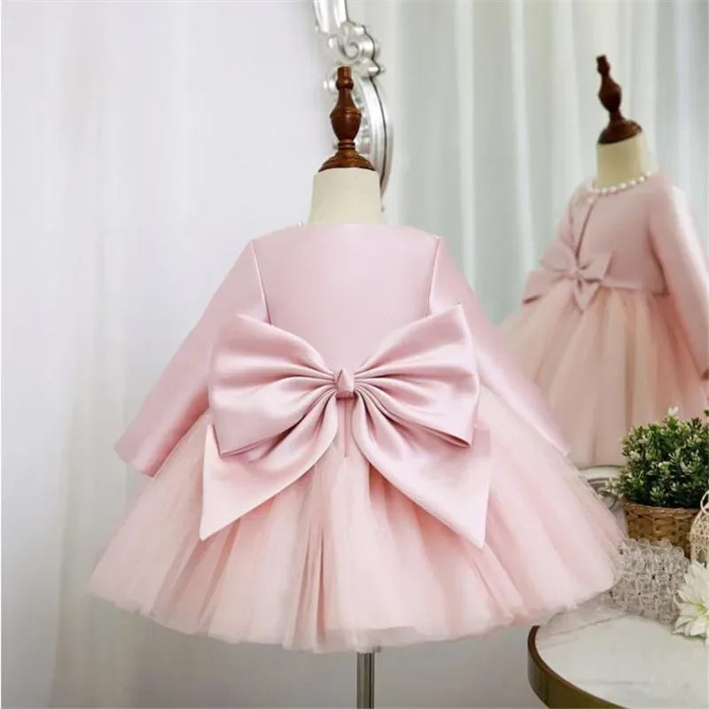 pink baptism dress for girls with long sleeves and large bow detail, toddler size