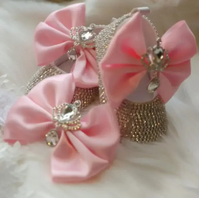 pink headpiece set for babies with large satin bows and sparkling rhinestone crowns