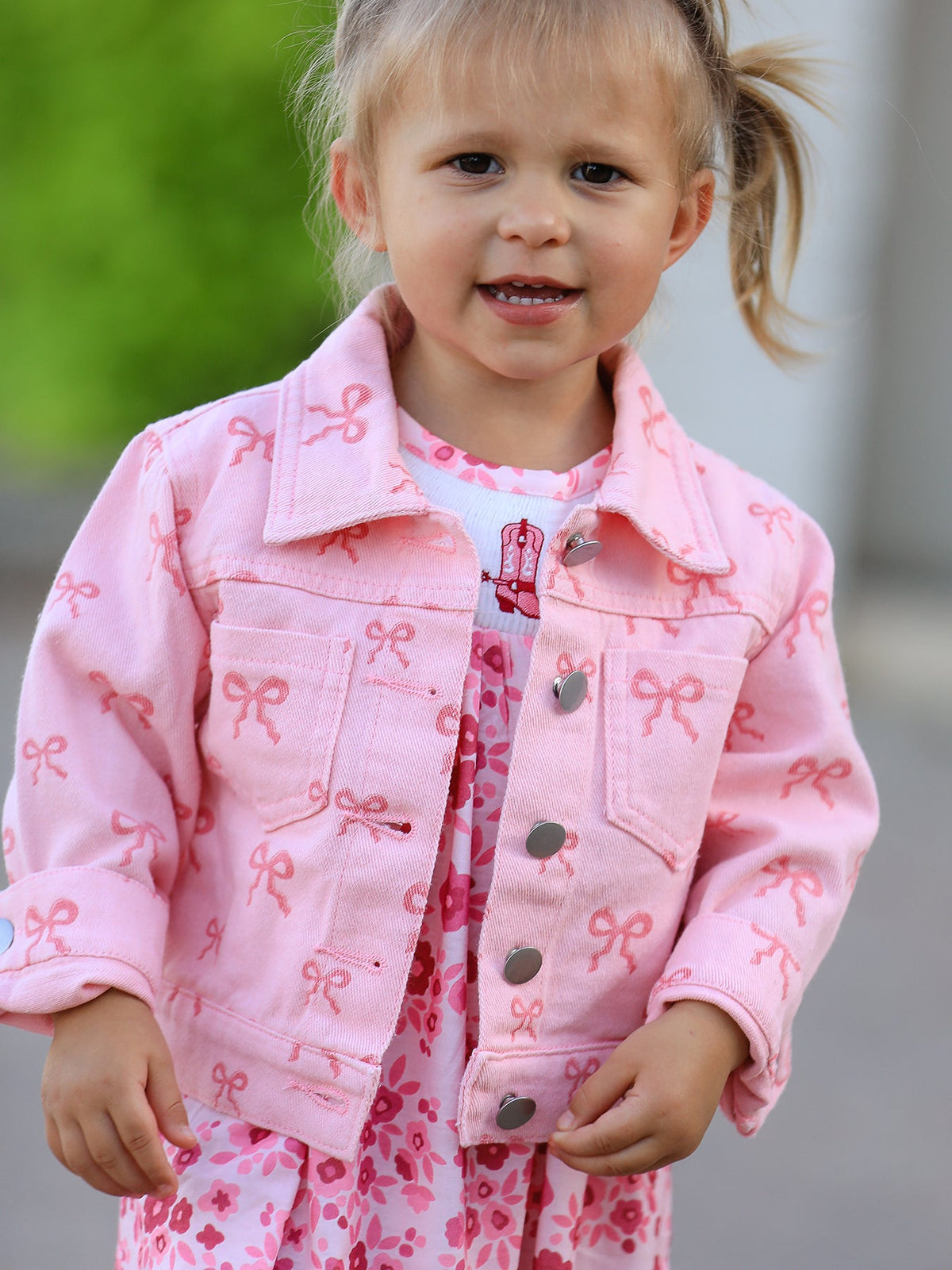Pink girls butterfly denim jacket for toddlers with all-over bow print and silver buttons