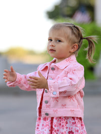 Toddler girl wearing pink girls butterfly denim jacket with bow print by Rylee Faith Designs