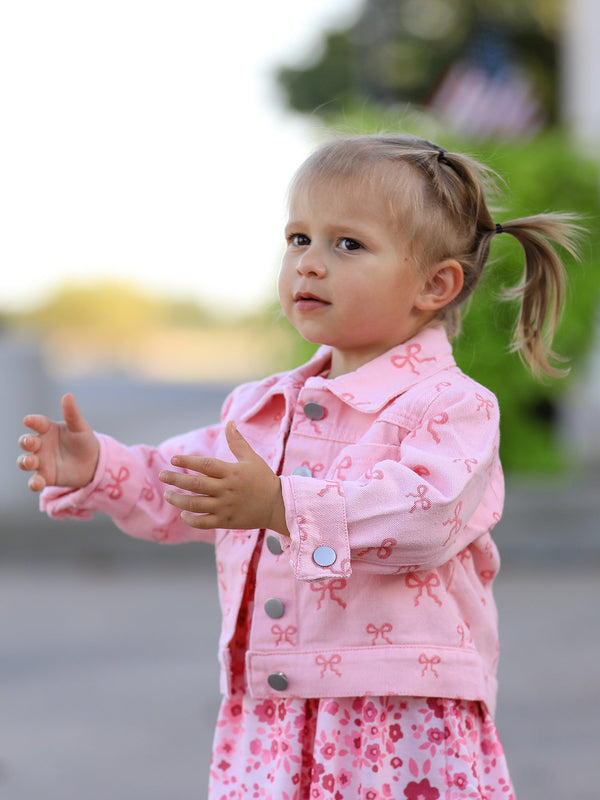 Toddler girl wearing pink girls butterfly denim jacket with bow print by Rylee Faith Designs