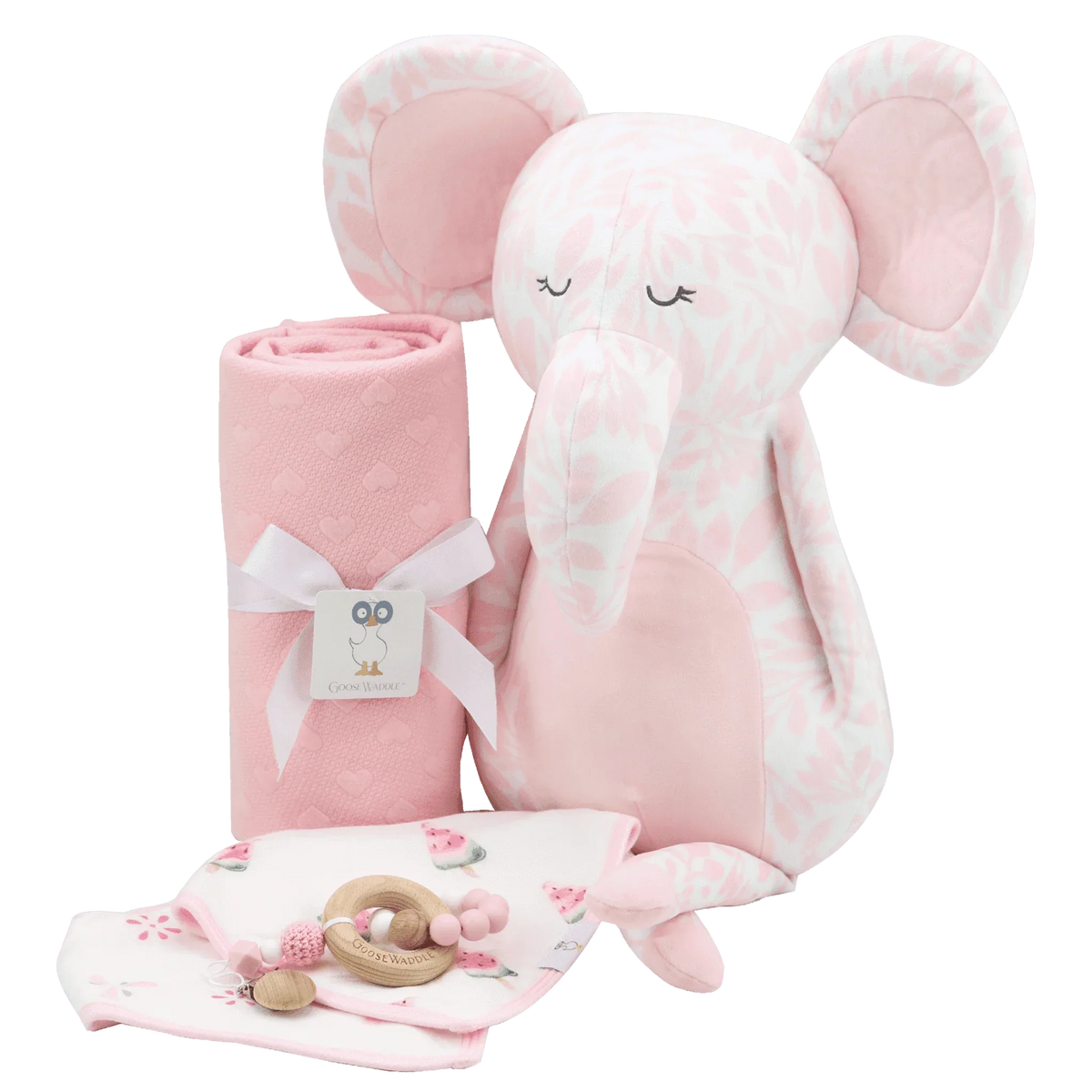 pink knit baby blanket rolled next to a pink patterned elephant plush and newborn teething toys