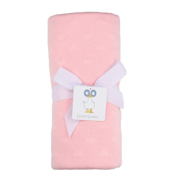 Goosewaddle pink knit baby blanket rolled and tied with white ribbon for newborns