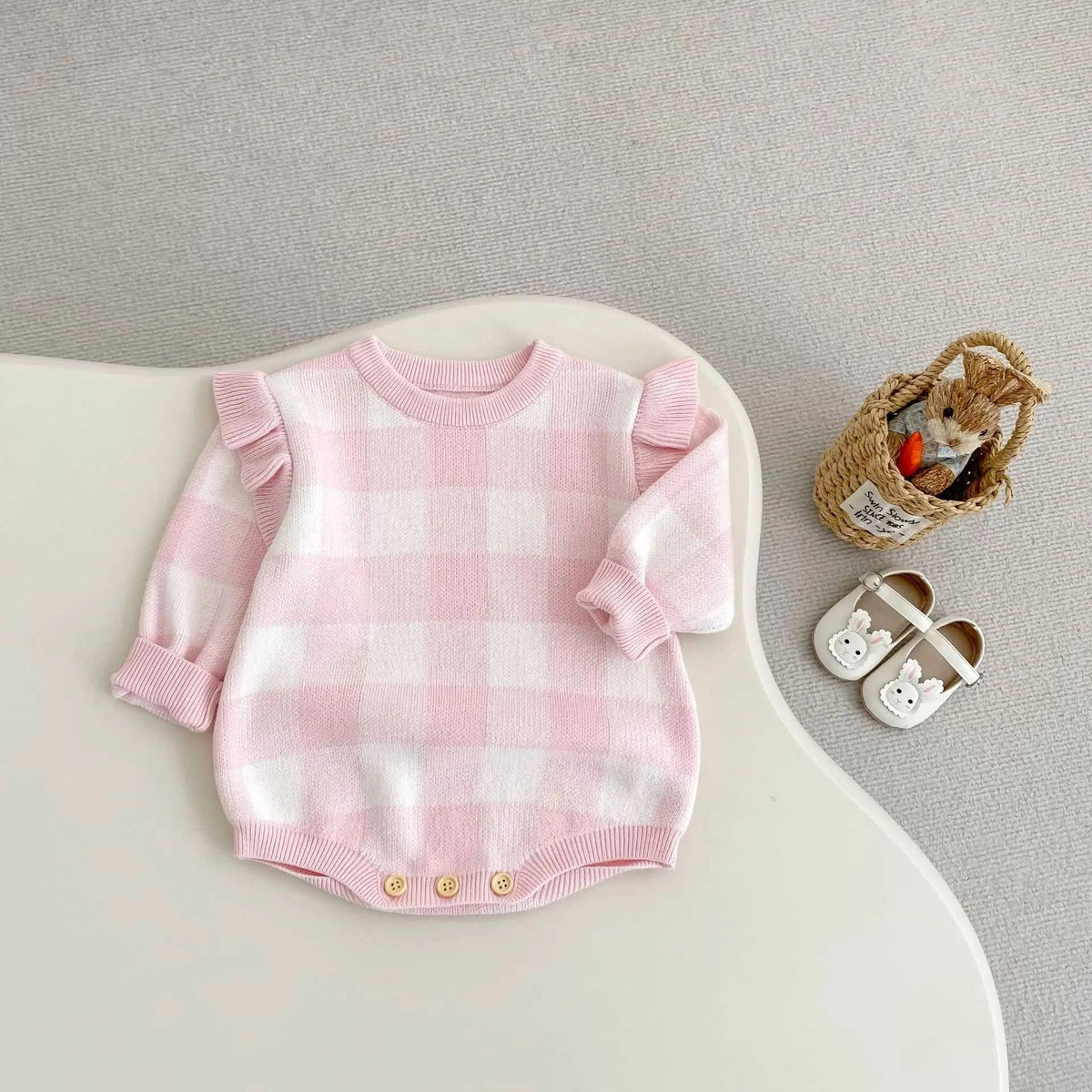 pink plaid baby romper for newborns with ruffle sleeves and button details