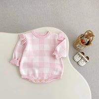 pink plaid baby romper for newborns with ruffle sleeves and button details