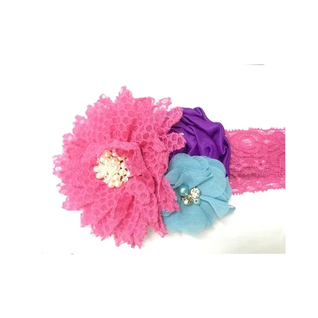 pink lace headband for babies with pink, purple, and blue flower hair accessories featuring pearl and rhinestone centers