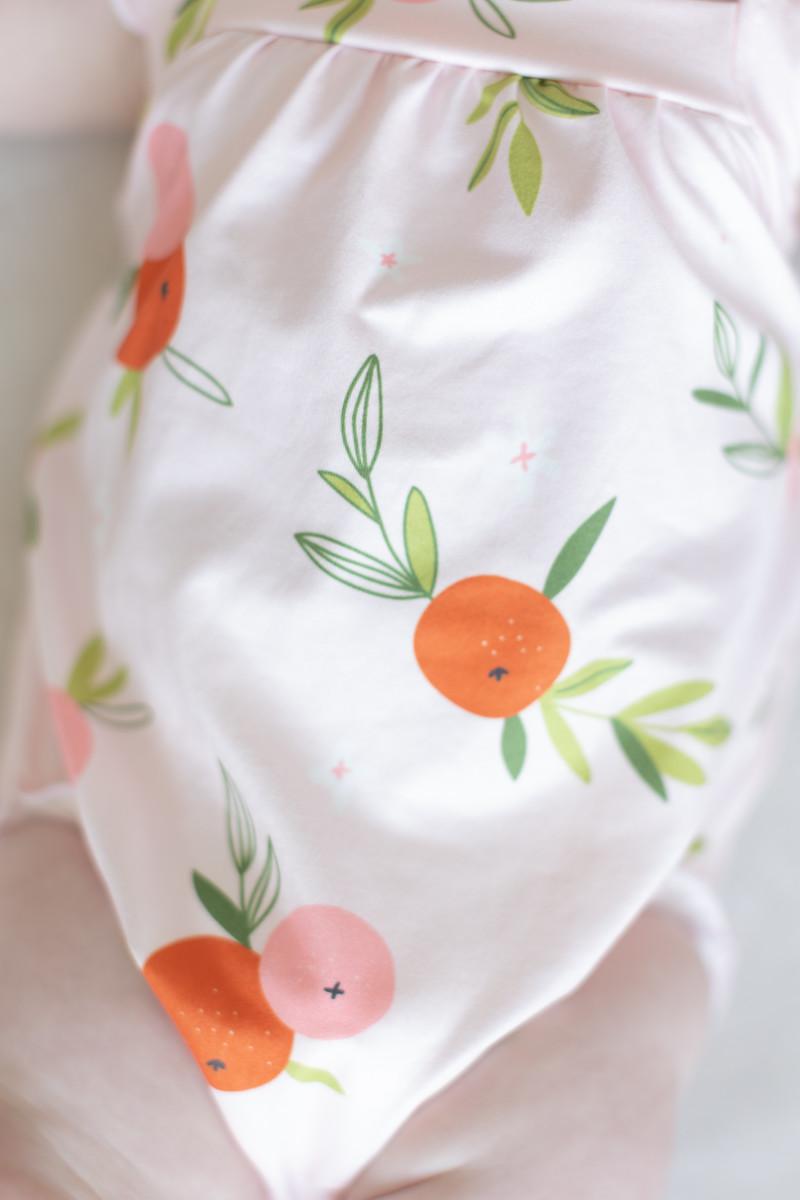 baby white romper ruffle with orange and pink fruit print and green leaves cross back design
