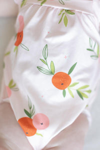 baby white romper ruffle with orange and pink fruit print and green leaves cross back design