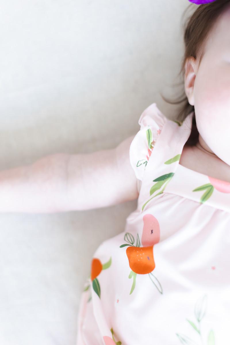 baby girl pink romper ruffle with cross back and orange fruit print sleeveless