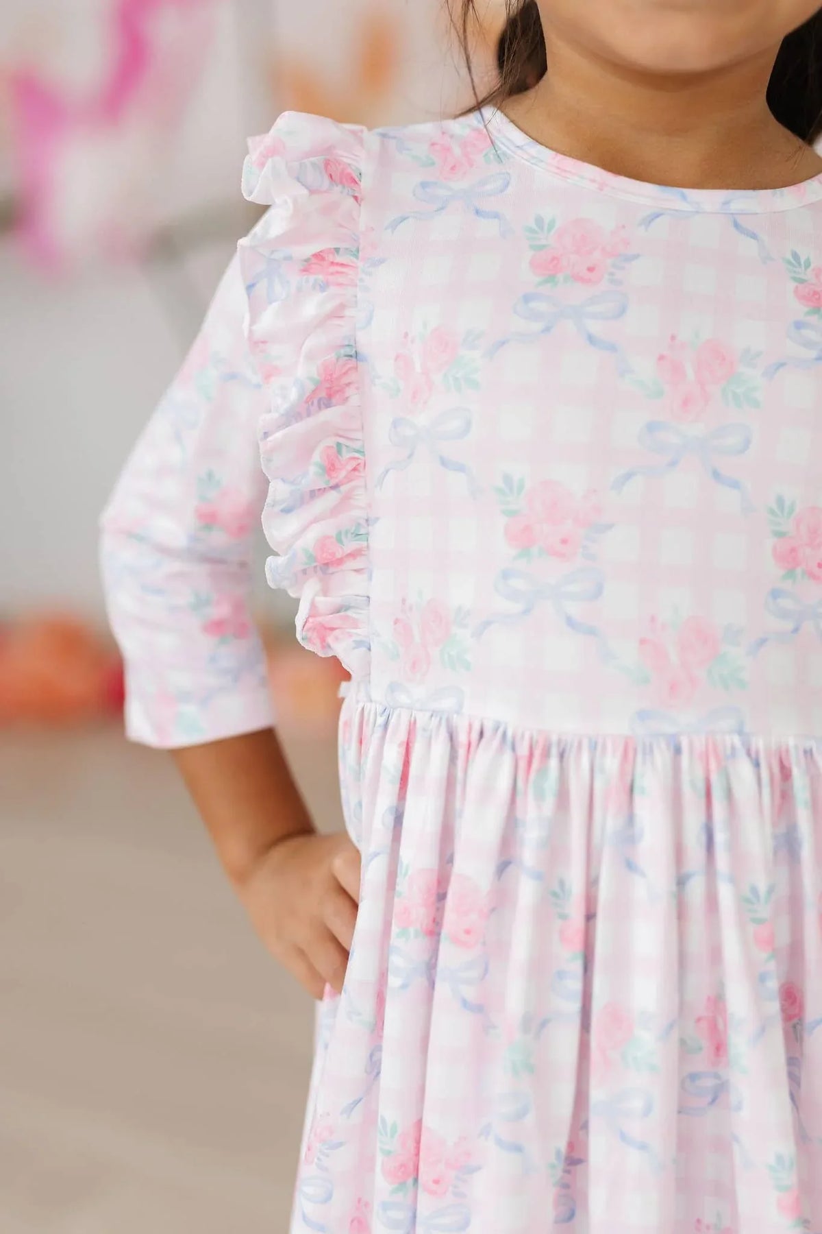 Girls pink ruffle twirl dress for girls by Mila & Rose with 3/4 sleeves and floral bow print