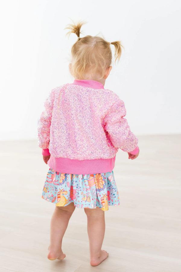 toddler girl wearing Mila & Rose pink sequin jacket for girls standing barefoot with back facing camera