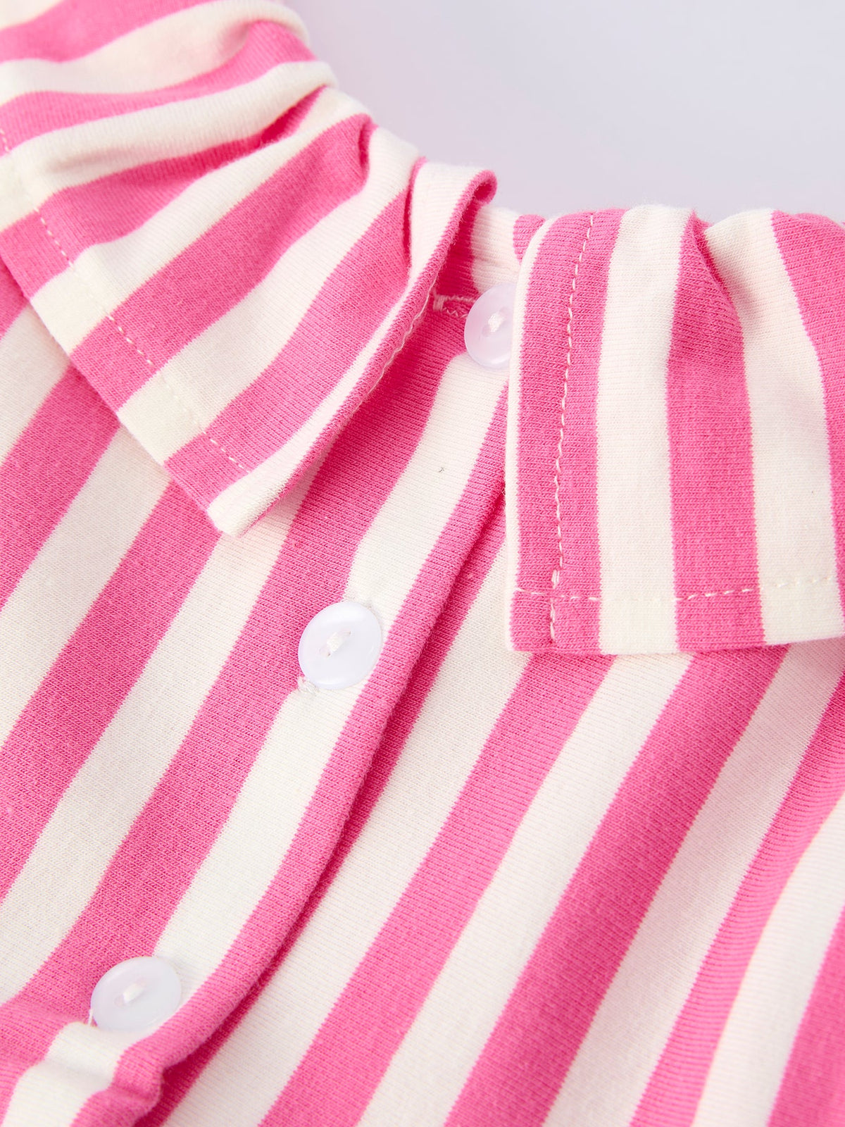 Close-up of pink striped girls dress with hat showing white buttons and collar detail by Rylee Faith Designs