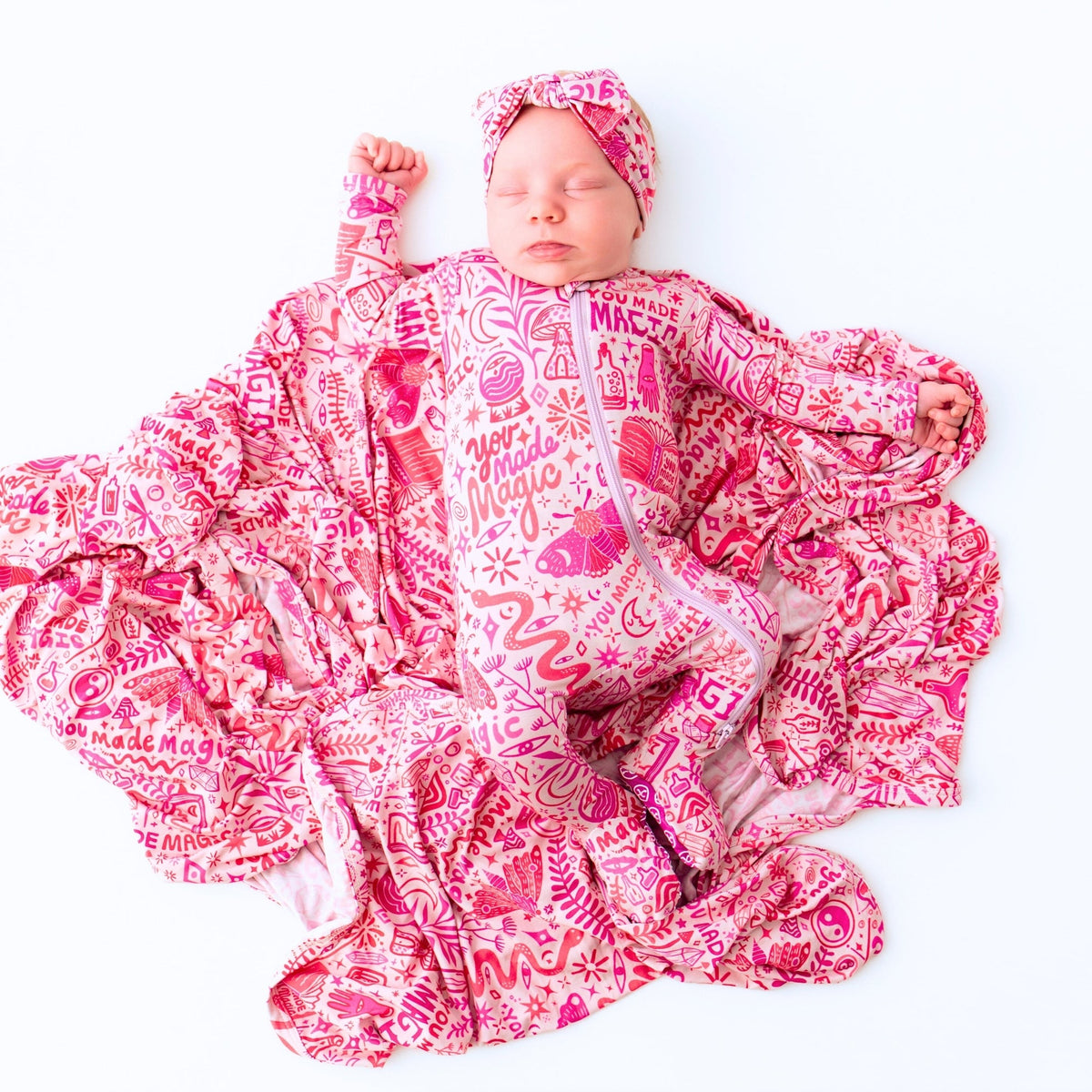 The Second-Skin Bamboo Zippered Footie | Mystic Mama displayed on a fluffy blanket, emphasizing its ultra-soft bamboo fabric.