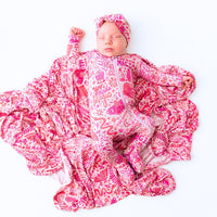The Second-Skin Bamboo Zippered Footie | Mystic Mama displayed on a fluffy blanket, emphasizing its ultra-soft bamboo fabric.