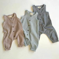 Plaid infant jumpsuit in brown, gray, and black colors with sleeveless design and button front for babies