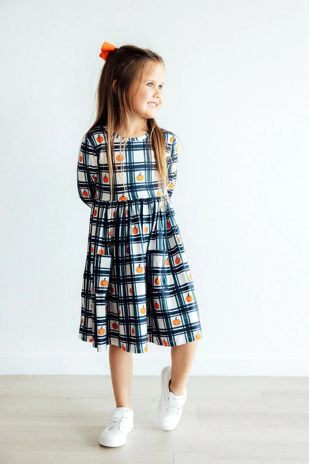 Girls plaid pumpkin dress for girls with long sleeve twirl design and pockets in navy and white