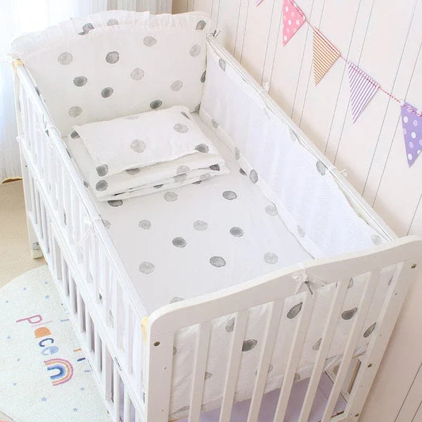 White planet baby crib bedding set for infants with grey polka dots and padded bumpers