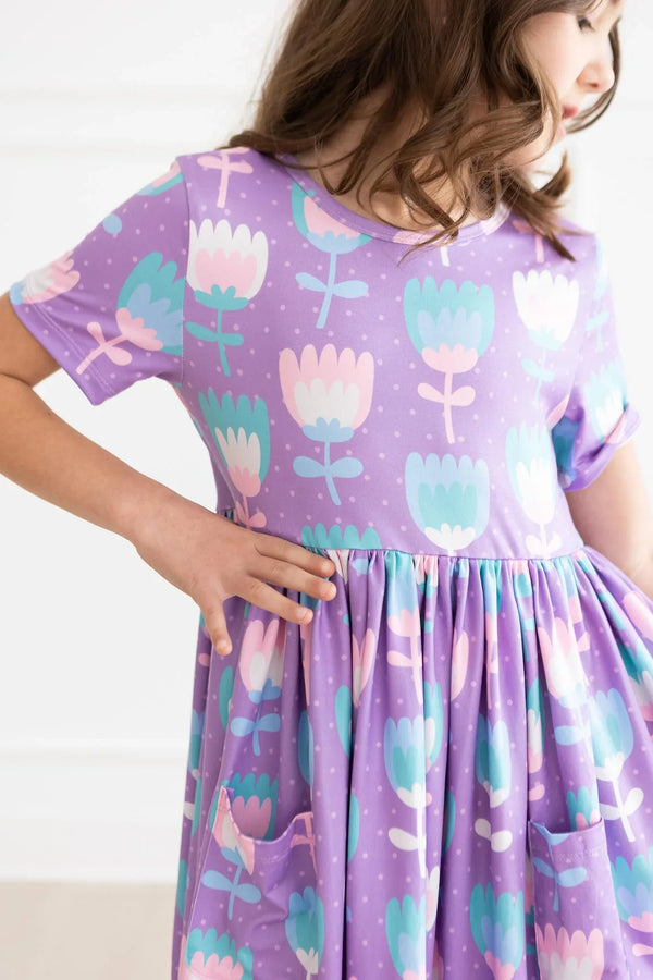 Girls purple pocket girls twirl dress with pastel floral print and short sleeves