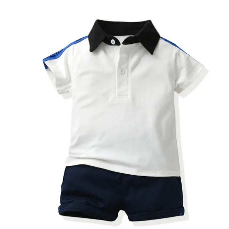 boys white and navy polo shorts set with black collar and blue stripe detail, toddler size