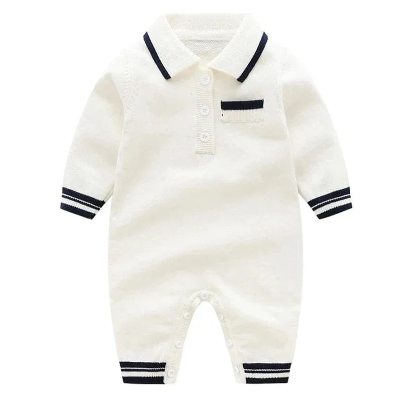 White preppy knit romper for babies with navy trim on collar, cuffs, and pocket detail