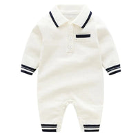 White preppy knit romper for babies with navy trim on collar, cuffs, and pocket detail