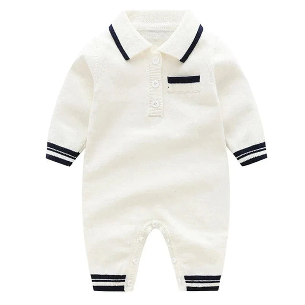 White preppy knit romper for babies with navy trim on collar, cuffs, and pocket detail